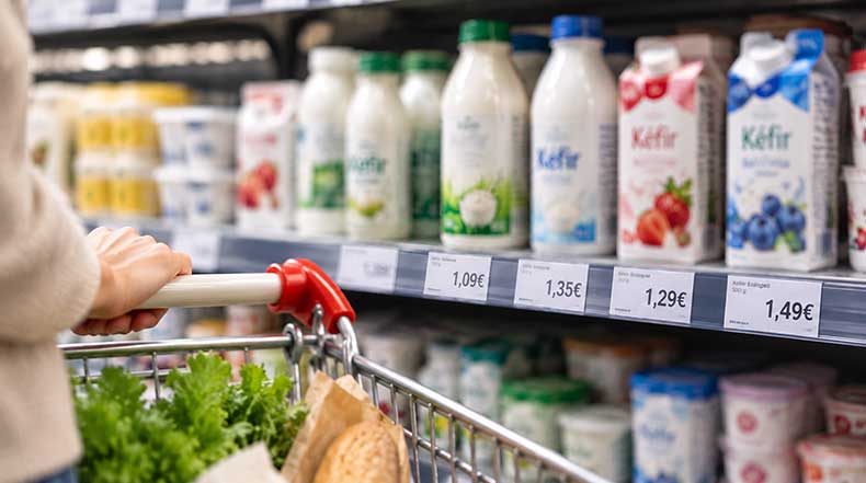 Precios de diferentes tipos de kéfir en la estantería refrigerada del supermercado